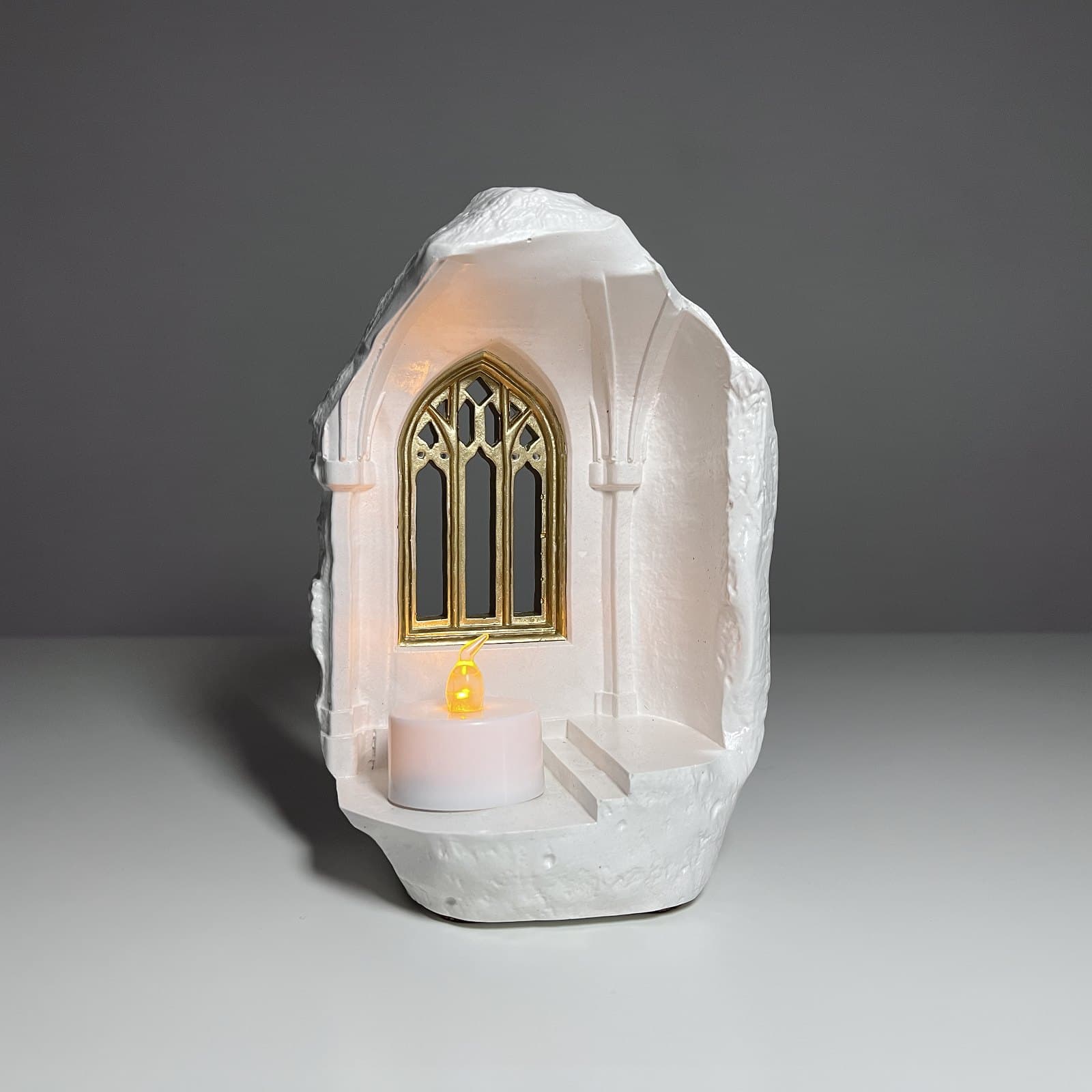 Castle candle holder with golden glowing windows
